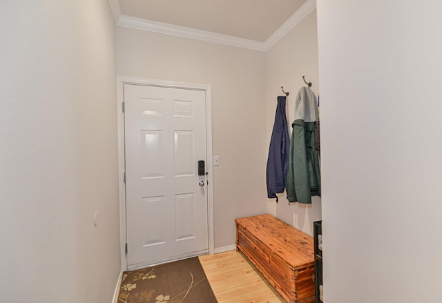 interior space with baseboards, light wood-style floors, and crown molding