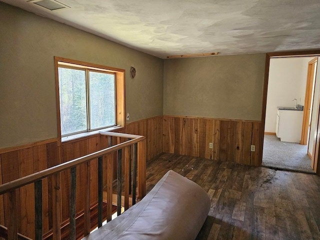 3610 Sand Creek Rd, Kettle Falls, WA 99141 - unfurnished room with wood walls, visible vents, a sink, wood-type flooring, and wainscoting