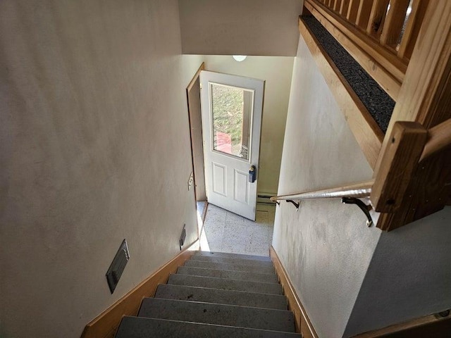 3610 Sand Creek Rd, Kettle Falls, WA 99141 - stairway with a baseboard radiator and speckled floor