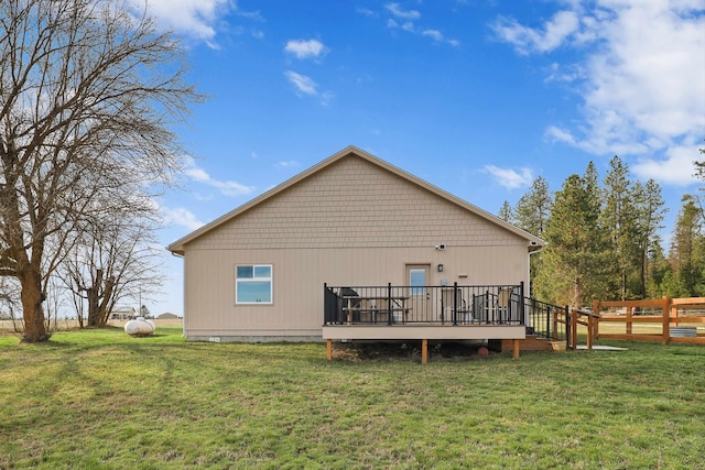 back of property featuring a wooden deck, fence, and a yard