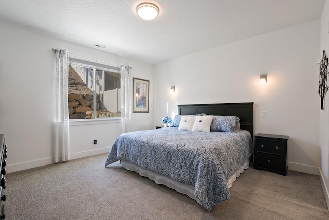 bedroom featuring baseboards, visible vents, and carpet