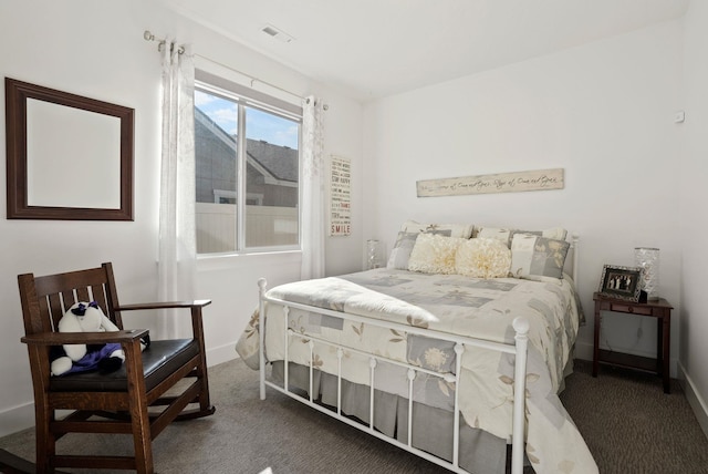 bedroom with carpet floors, baseboards, and visible vents
