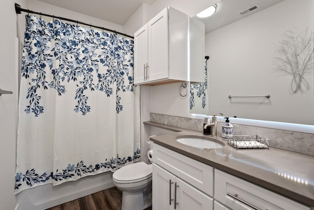full bathroom featuring visible vents, wood finished floors, toilet, and vanity