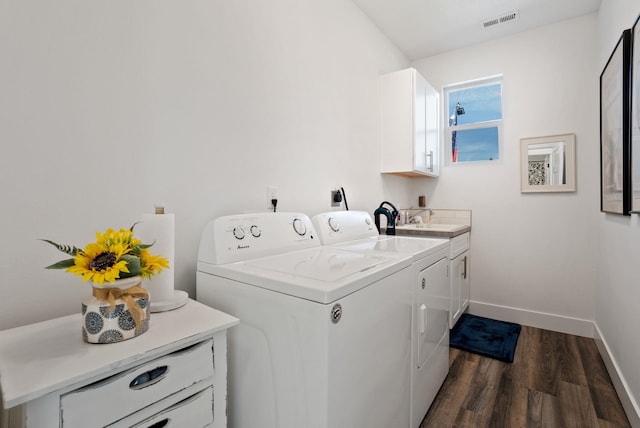 laundry area with separate washer and dryer, baseboards, visible vents, cabinet space, and dark wood-type flooring