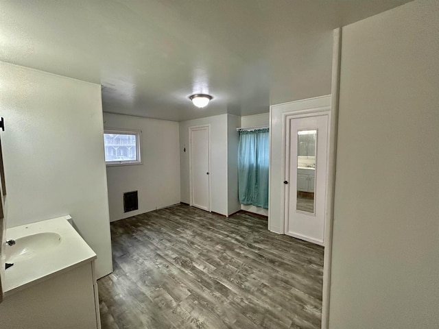 bathroom featuring visible vents, vanity, and wood finished floors