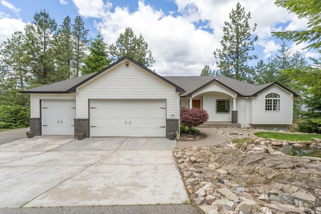 4720 S Wildwood Ln, Spokane, WA 99206 - ranch-style house featuring driveway, brick siding, a garage, and a shingled roof