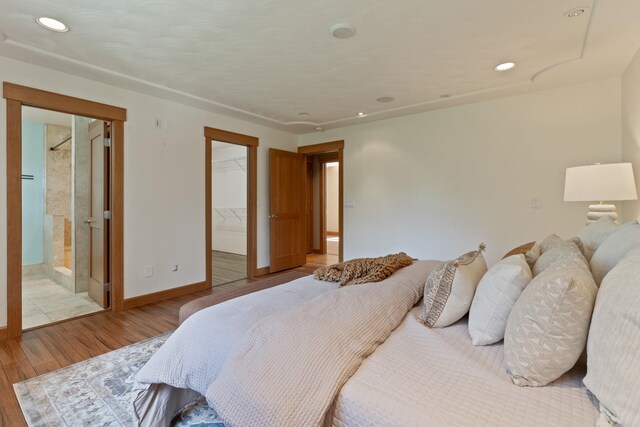 4720 S Wildwood Ln, Spokane, WA 99206 - bedroom featuring a walk in closet, recessed lighting, baseboards, a closet, and wood finished floors