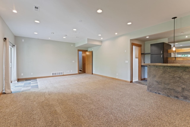 4720 S Wildwood Ln, Spokane, WA 99206 - unfurnished living room with visible vents, recessed lighting, and light colored carpet