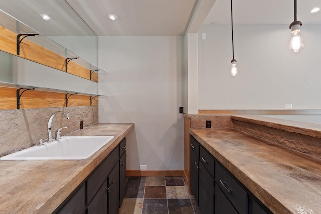 4720 S Wildwood Ln, Spokane, WA 99206 - full bathroom with vanity, recessed lighting, stone finish floor, baseboards, and backsplash