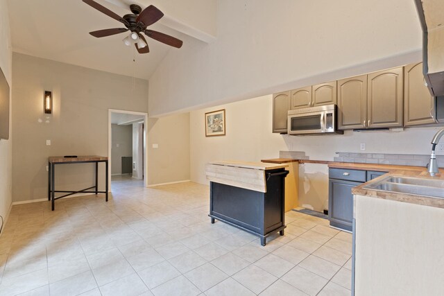 4720 S Wildwood Ln, Spokane, WA 99206 - kitchen featuring light countertops, stainless steel microwave, light tile patterned floors, a sink, and a ceiling fan