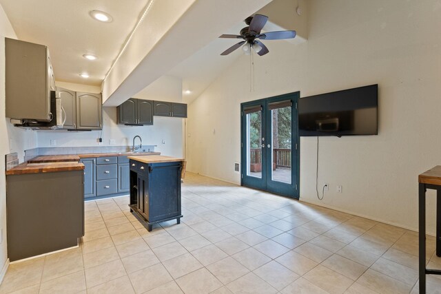 4720 S Wildwood Ln, Spokane, WA 99206 - kitchen featuring light tile patterned flooring, butcher block counters, a ceiling fan, a sink, and french doors