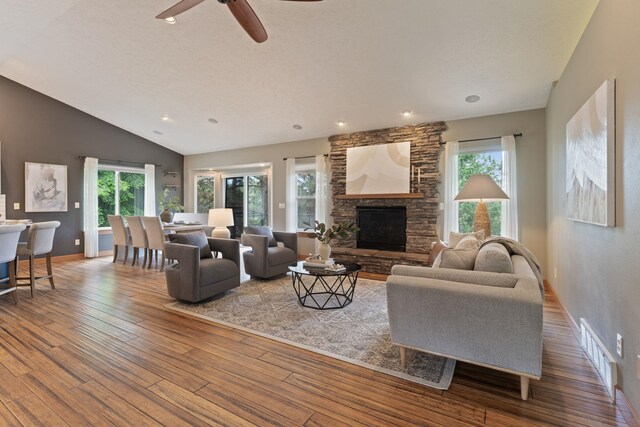 4720 S Wildwood Ln, Spokane, WA 99206 - living area featuring plenty of natural light, a stone fireplace, hardwood / wood-style flooring, and visible vents