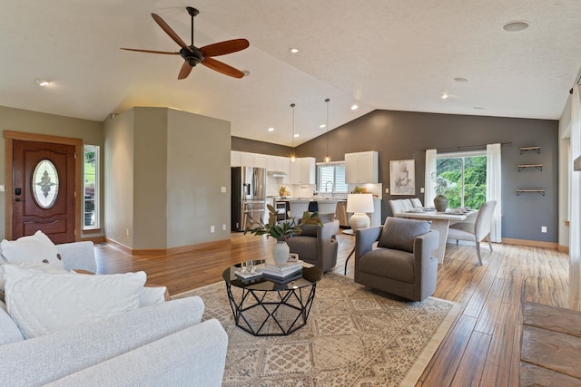 4720 S Wildwood Ln, Spokane, WA 99206 - living room with baseboards, lofted ceiling, light wood-style flooring, and ceiling fan
