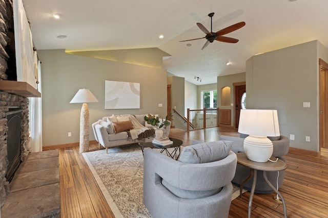 4720 S Wildwood Ln, Spokane, WA 99206 - living room featuring vaulted ceiling, a fireplace, wood finished floors, baseboards, and ceiling fan