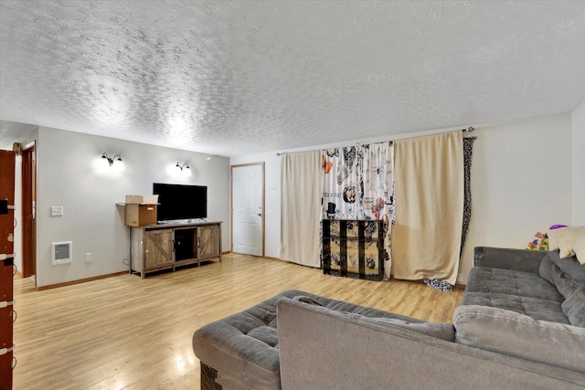 908 E Rockwell Avenue 910E Rockwell Ave, Spokane, WA 99207 - living room featuring baseboards, visible vents, a textured ceiling, and wood finished floors