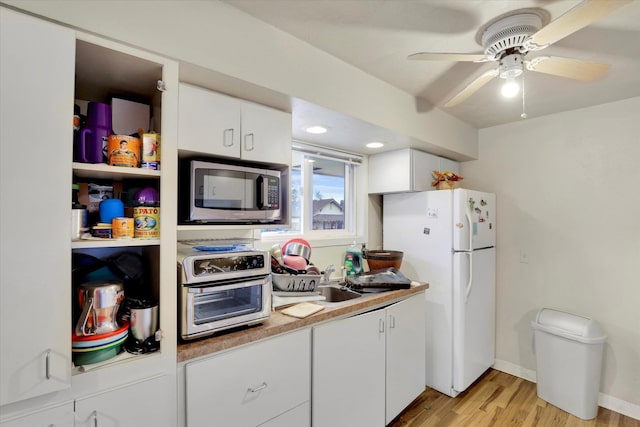 908 E Rockwell Avenue 910E Rockwell Ave, Spokane, WA 99207 - kitchen featuring a sink, freestanding refrigerator, light wood-style flooring, stainless steel microwave, and white cabinets