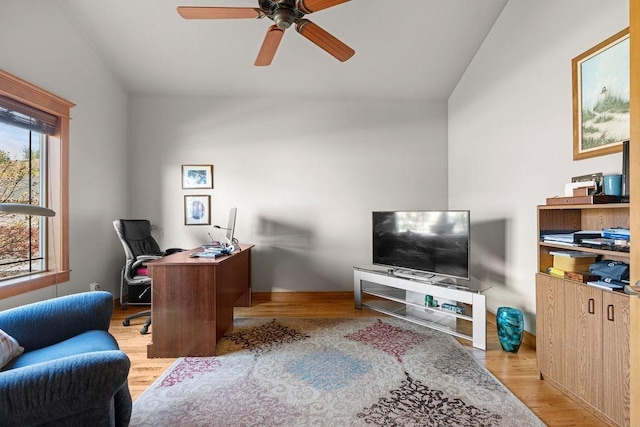office featuring lofted ceiling, wood finished floors, ceiling fan, and baseboards