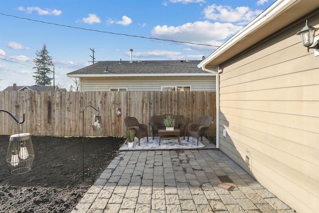 detached garage featuring driveway and fence