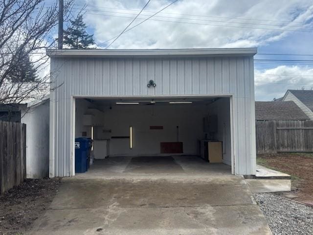 detached garage featuring fence