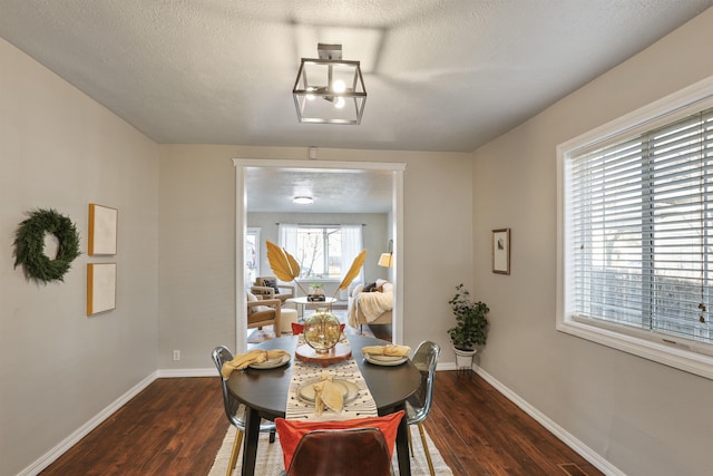 kitchen featuring a textured ceiling, decorative backsplash, light wood-style flooring, appliances with stainless steel finishes, and baseboards