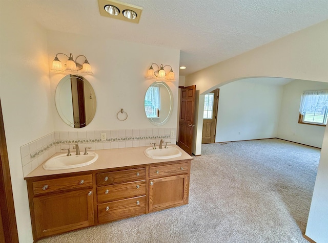 bathroom featuring double vanity, a sink, and a textured ceiling