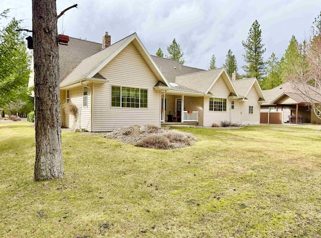 single story home with a chimney, roof with shingles, and a front lawn