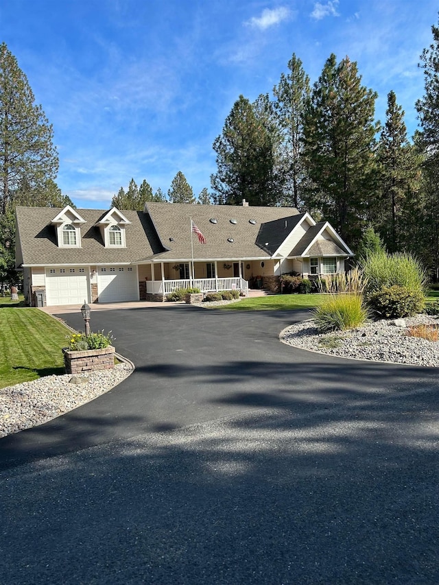 view of front of property featuring driveway, a shingled roof, and an attached garage