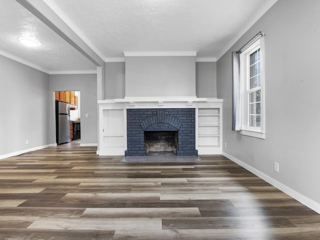 unfurnished living room featuring ornamental molding, a textured ceiling, baseboards, and wood finished floors