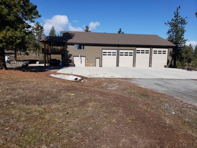 21319 E Harvard Vistas Ln, Newman Lake, WA 99025 - view of front of house featuring concrete driveway and a wooden deck