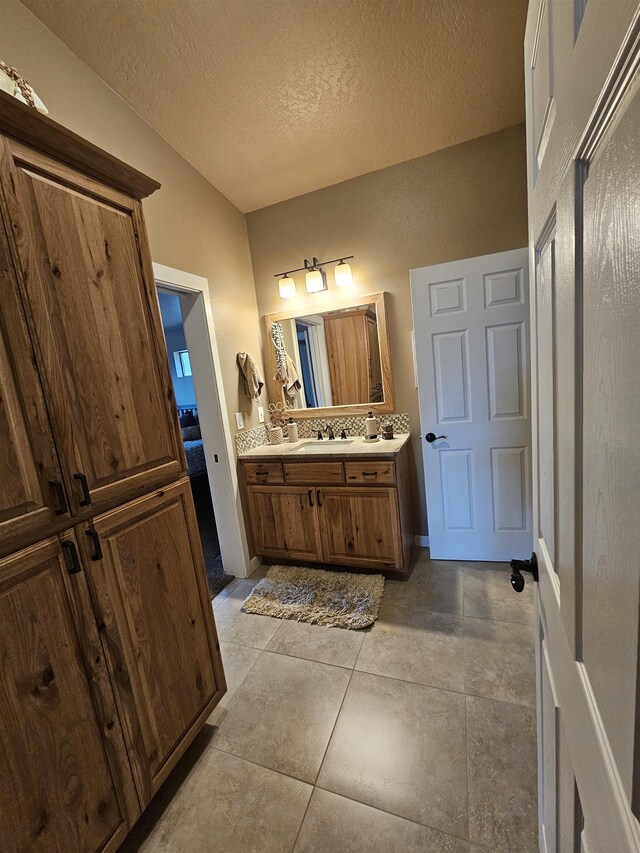 21319 E Harvard Vistas Ln, Newman Lake, WA 99025 - full bathroom with double vanity and a textured ceiling