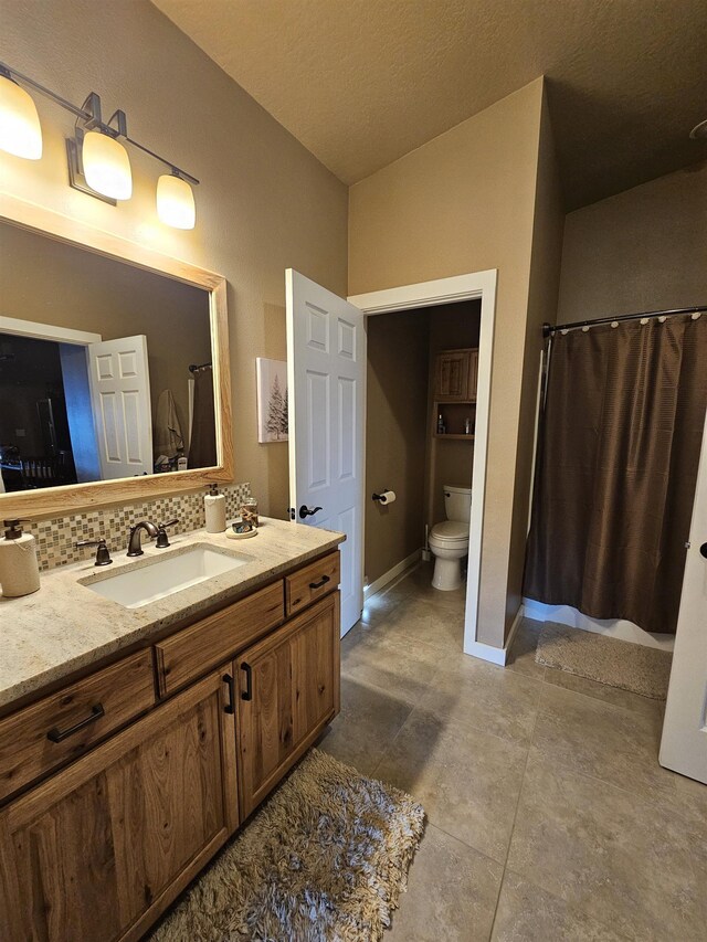 21319 E Harvard Vistas Ln, Newman Lake, WA 99025 - full bath with vanity, toilet, a shower with curtain, backsplash, and tile patterned floors