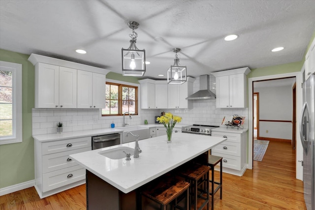 6814 S Jackson Ridge Ln, Greenacres, WA 99016 - kitchen featuring wall chimney exhaust hood, appliances with stainless steel finishes, baseboards, light countertops, and backsplash