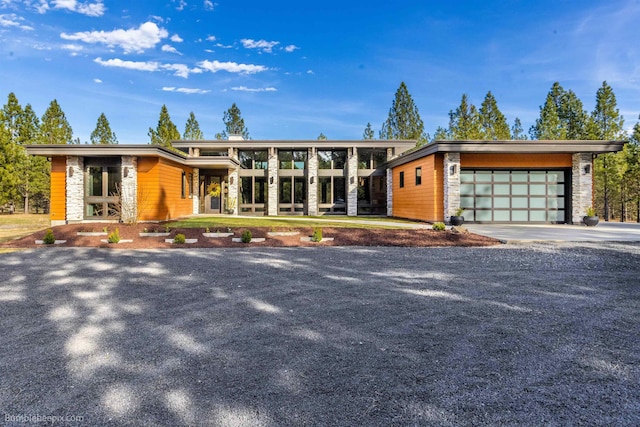 27809 N Bruce Rd, Chattaroy, WA 99003 - modern home with stone siding, driveway, and a garage
