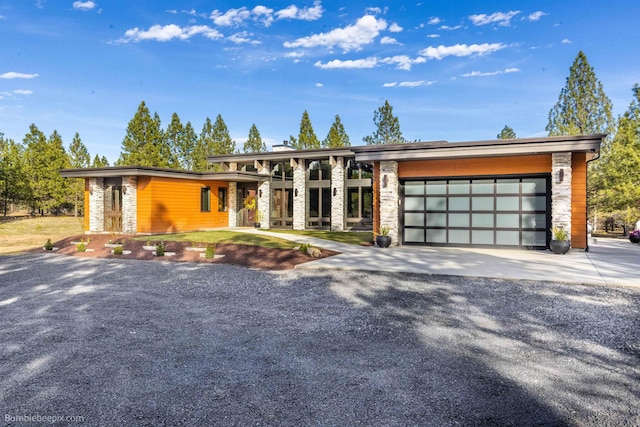 27809 N Bruce Rd, Chattaroy, WA 99003 - view of front of property with driveway, an attached garage, and stone siding