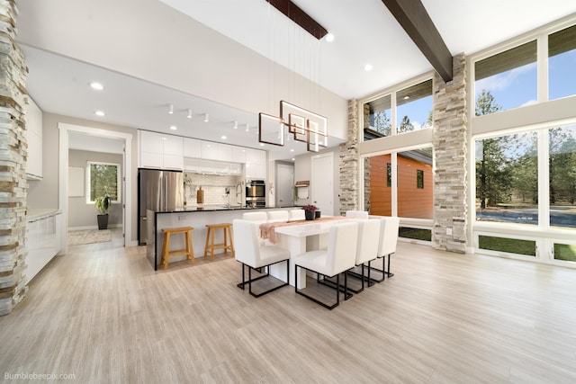 27809 N Bruce Rd, Chattaroy, WA 99003 - interior space featuring modern cabinets, a wealth of natural light, a center island, and tasteful backsplash