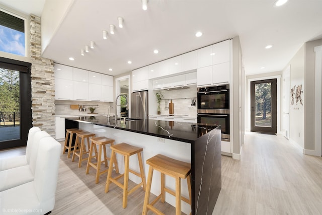 27809 N Bruce Rd, Chattaroy, WA 99003 - kitchen with a sink, modern cabinets, stainless steel appliances, and decorative backsplash