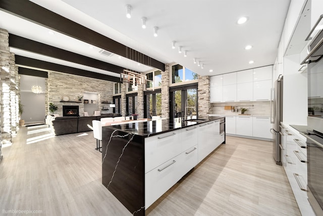 27809 N Bruce Rd, Chattaroy, WA 99003 - kitchen featuring backsplash, white cabinetry, modern cabinets, stainless steel appliances, and visible vents
