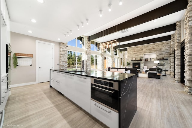 27809 N Bruce Rd, Chattaroy, WA 99003 - kitchen featuring visible vents, oven, modern cabinets, dark countertops, and a sink