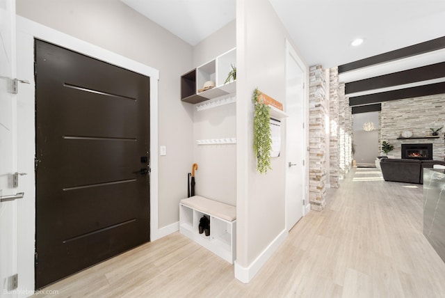27809 N Bruce Rd, Chattaroy, WA 99003 - mudroom with baseboards, beamed ceiling, a tiled fireplace, and wood finished floors