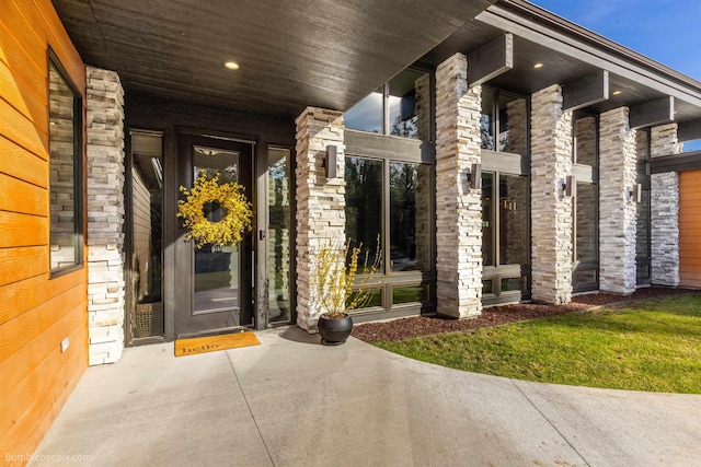 27809 N Bruce Rd, Chattaroy, WA 99003 - view of exterior entry with stone siding and a porch