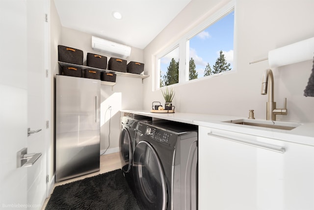 27809 N Bruce Rd, Chattaroy, WA 99003 - washroom with washing machine and dryer, a wall mounted AC, a sink, light wood-type flooring, and recessed lighting