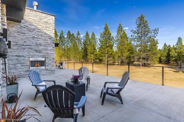 27809 N Bruce Rd, Chattaroy, WA 99003 - view of patio with an outdoor stone fireplace and fence