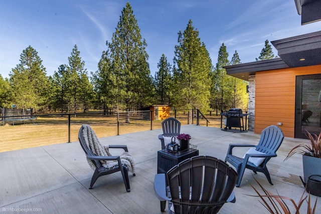 27809 N Bruce Rd, Chattaroy, WA 99003 - view of patio / terrace with grilling area, an outbuilding, fence, and a trampoline
