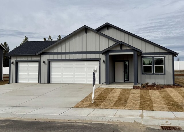 805 E 5th St, Deer Park, WA 99006 - view of front of property with a garage, board and batten siding, concrete driveway, and roof with shingles