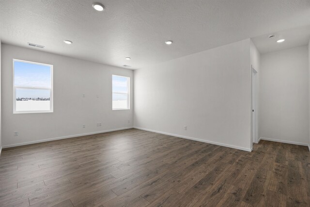 805 E 5th St, Deer Park, WA 99006 - spare room with dark wood-style floors, visible vents, recessed lighting, and baseboards