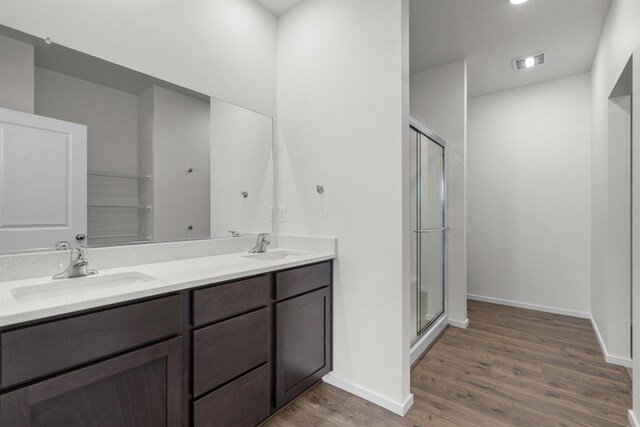 805 E 5th St, Deer Park, WA 99006 - bathroom with wood finished floors, a sink, a shower stall, and visible vents
