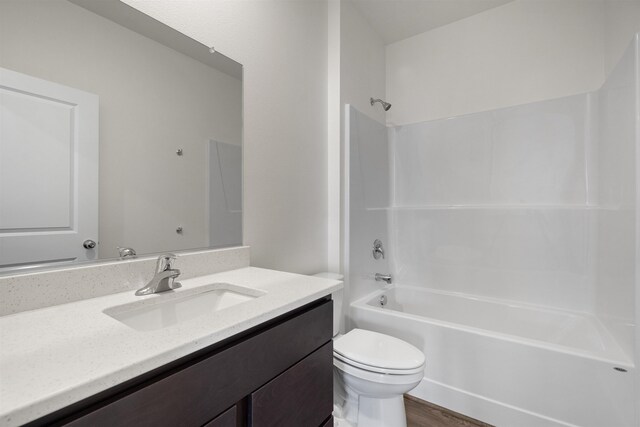805 E 5th St, Deer Park, WA 99006 - bathroom with toilet, vanity,  shower combination, and wood finished floors