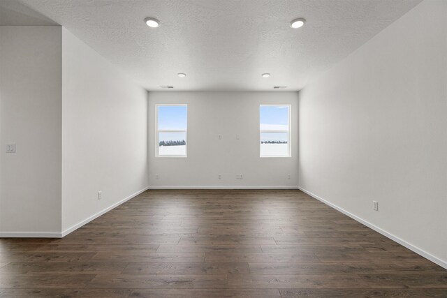 805 E 5th St, Deer Park, WA 99006 - empty room with baseboards, a textured ceiling, dark wood-type flooring, and a healthy amount of sunlight