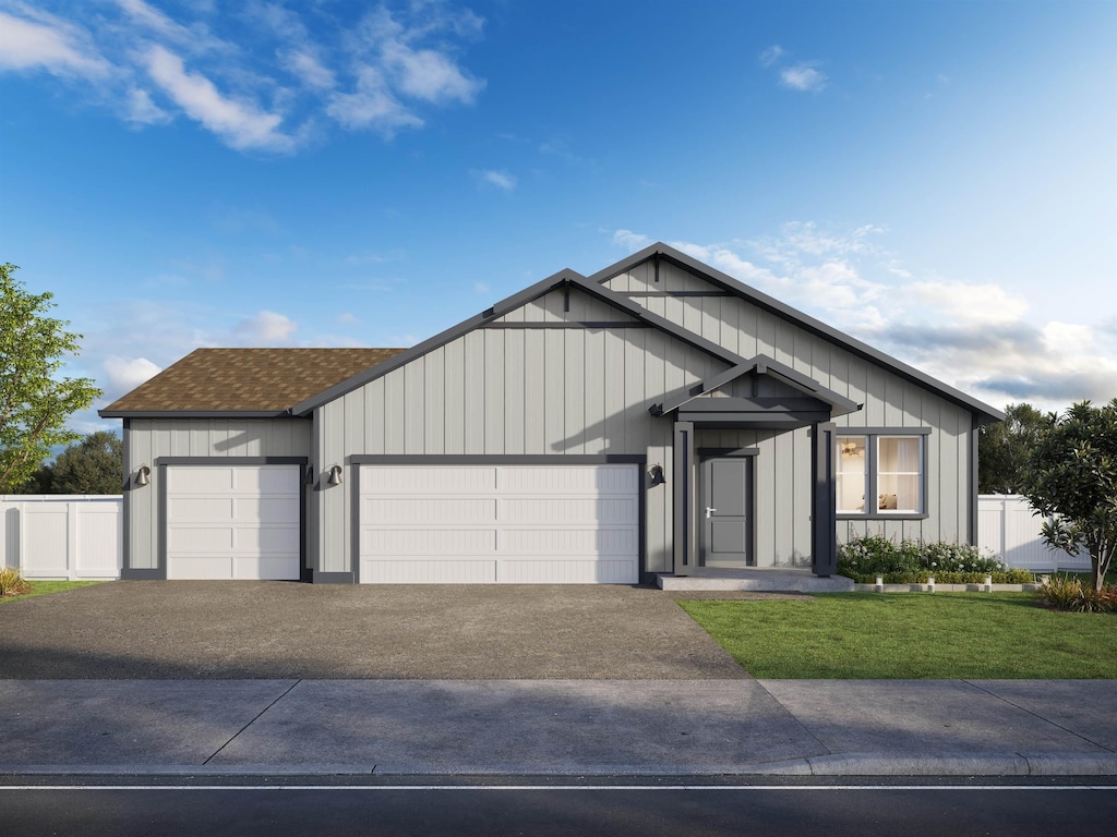 view of front of home with a front yard, fence, an attached garage, board and batten siding, and aphalt driveway