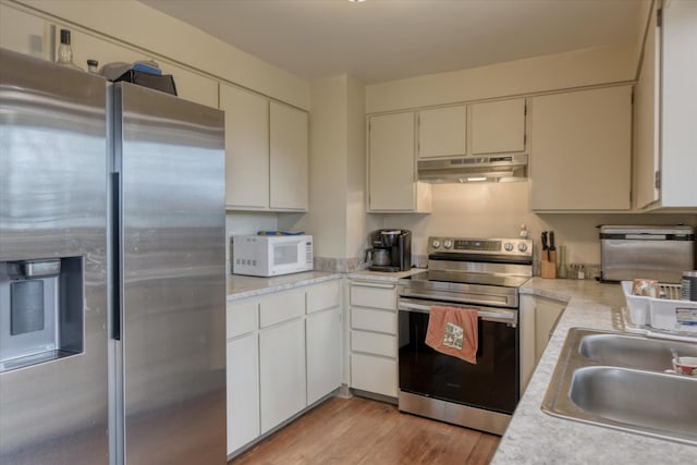 4718 N Campbell Rd, Otis Orchards, WA 99027 - kitchen featuring appliances with stainless steel finishes, under cabinet range hood, a sink, and light countertops